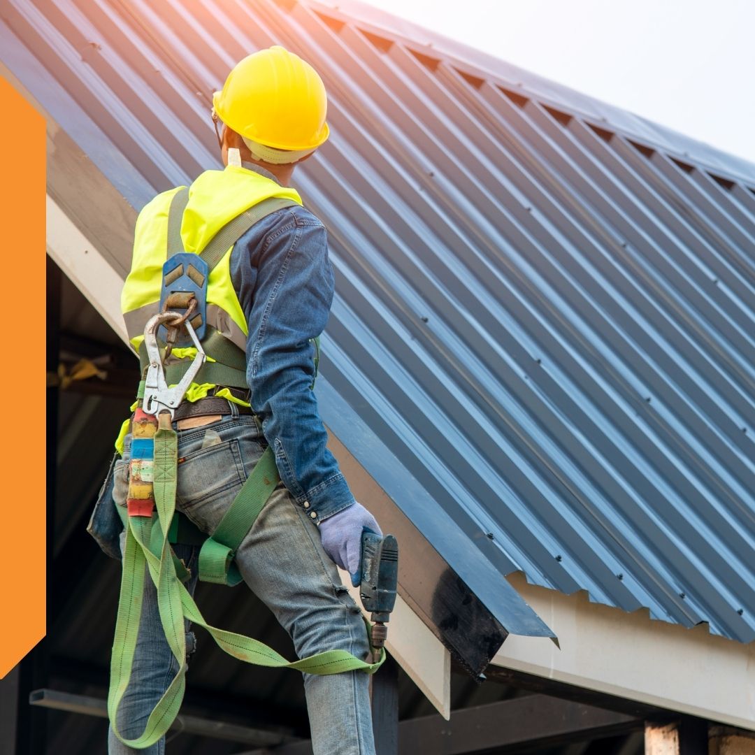 worker inspecting newly installed metal roof