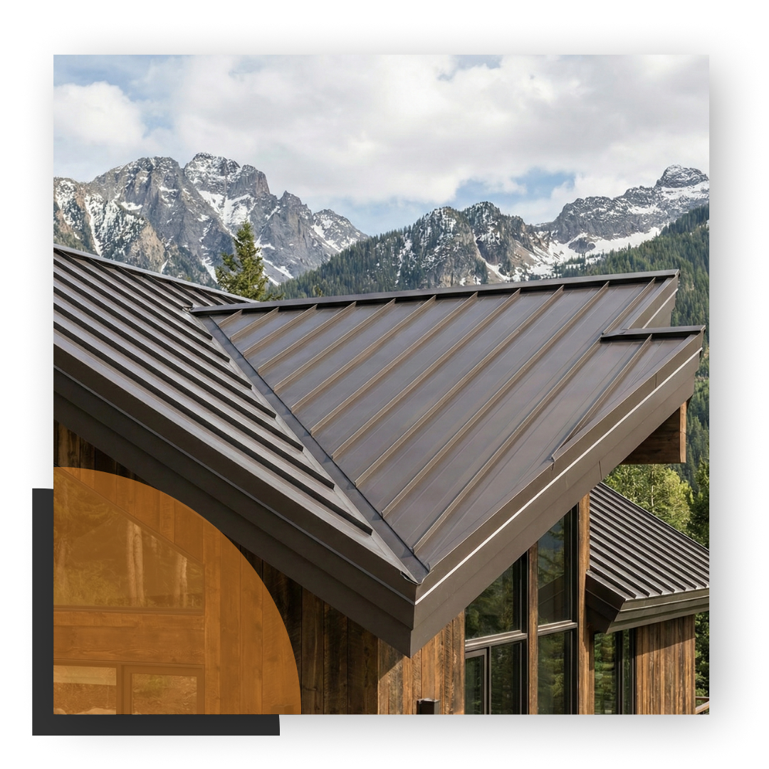 A modern mountain home with a dark brown standing-seam metal roof and timber accents below the snow-capped peaks of Eagle County