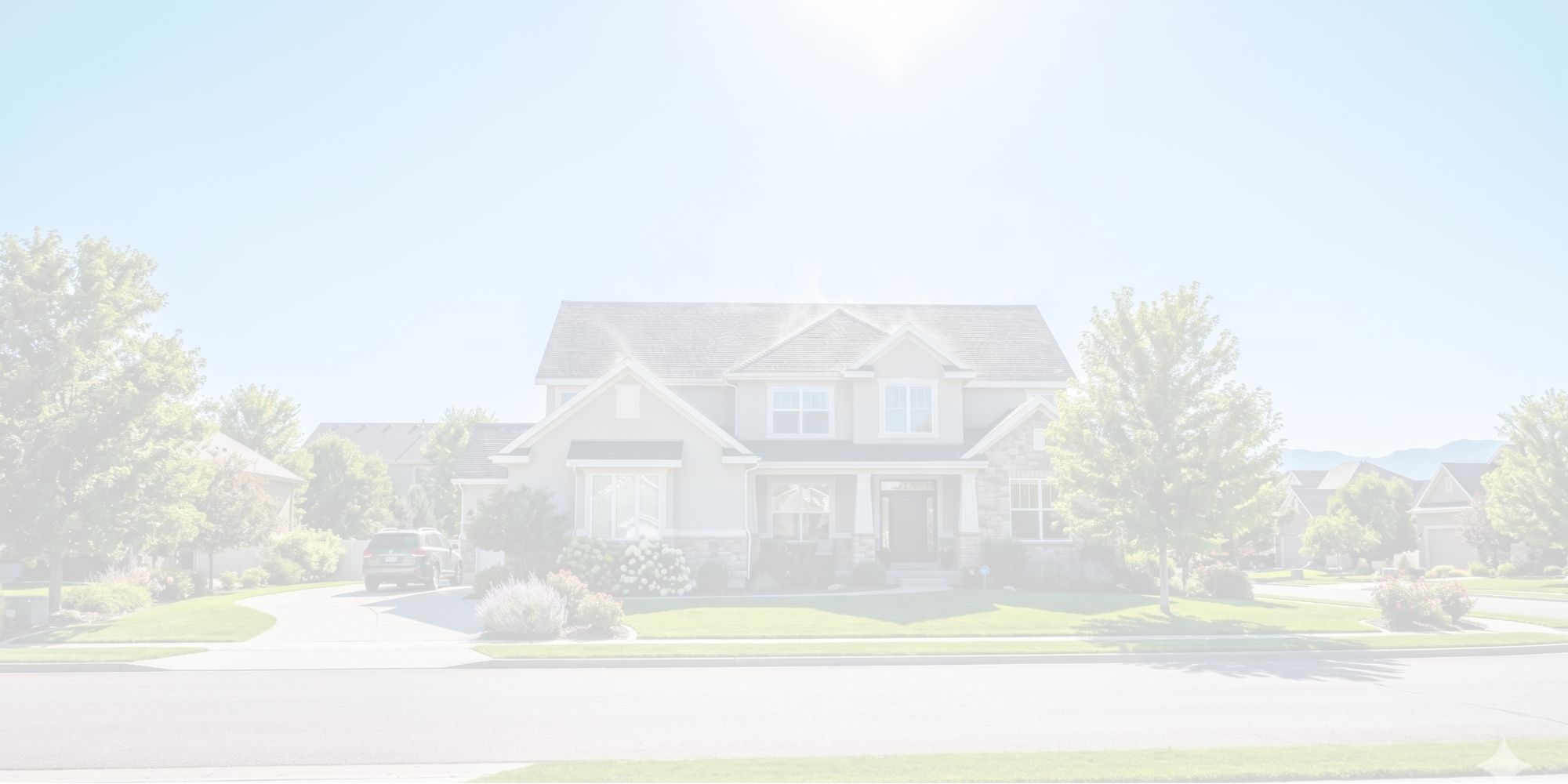 Residential house with shingle roof under intense bright summer sun and clear blue sky.
